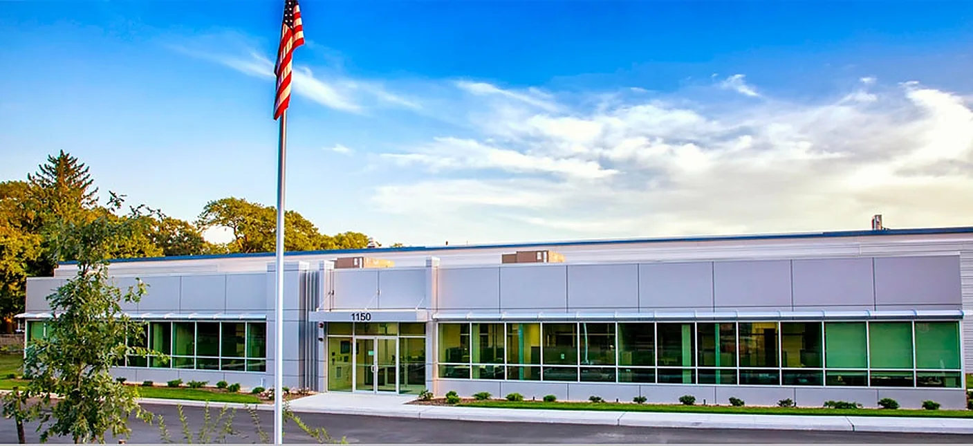 Front of the Autronic Plastics headquarters at 1150 Motor Parkway, Central Islip, New York, with the American flag out front